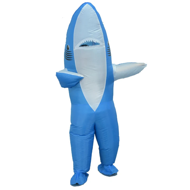 Inflatable blue shark costume with white belly and fin details. The costume has an open mouth and cartoonish eyes, giving a playful and whimsical appearance.