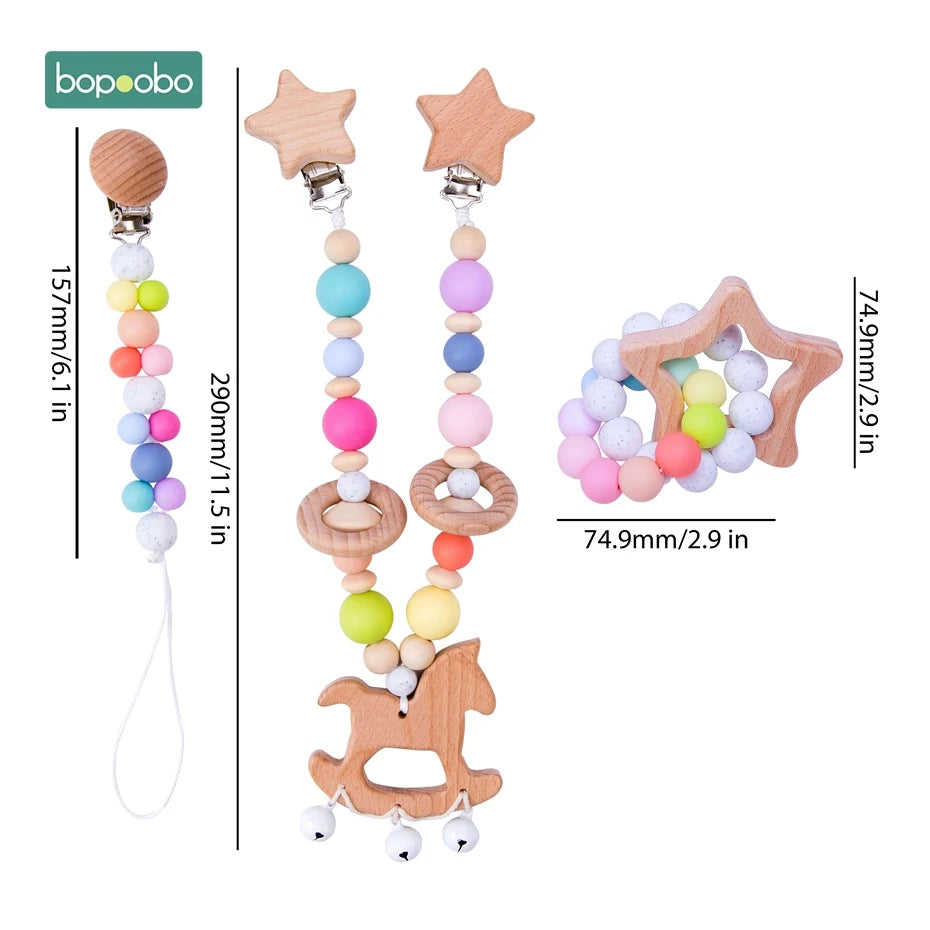 Colorful baby teething toys made of wood and silicone beads, featuring star and horse shapes. Two clip-on chains measure 11.5 in and 6.1 in, star-shaped ring is 2.9 in wide.