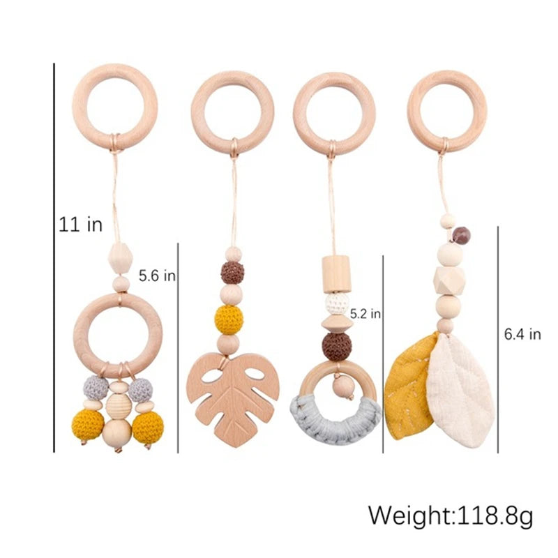 Four wooden baby mobiles with rings at the top, featuring beads and shapes in gray, yellow, and natural wood tones. Sizes range from 5.2 to 11 inches. Total weight: 118.8g.
