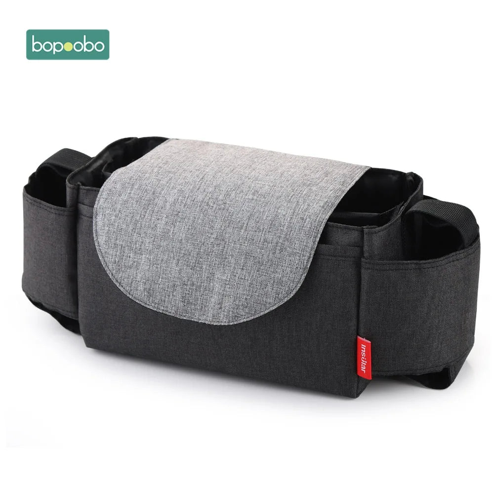 Gray and black stroller organizer with multiple pockets and a flap closure, featuring the red Insular label on the side. The Bopoobo logo is displayed in the top left corner.