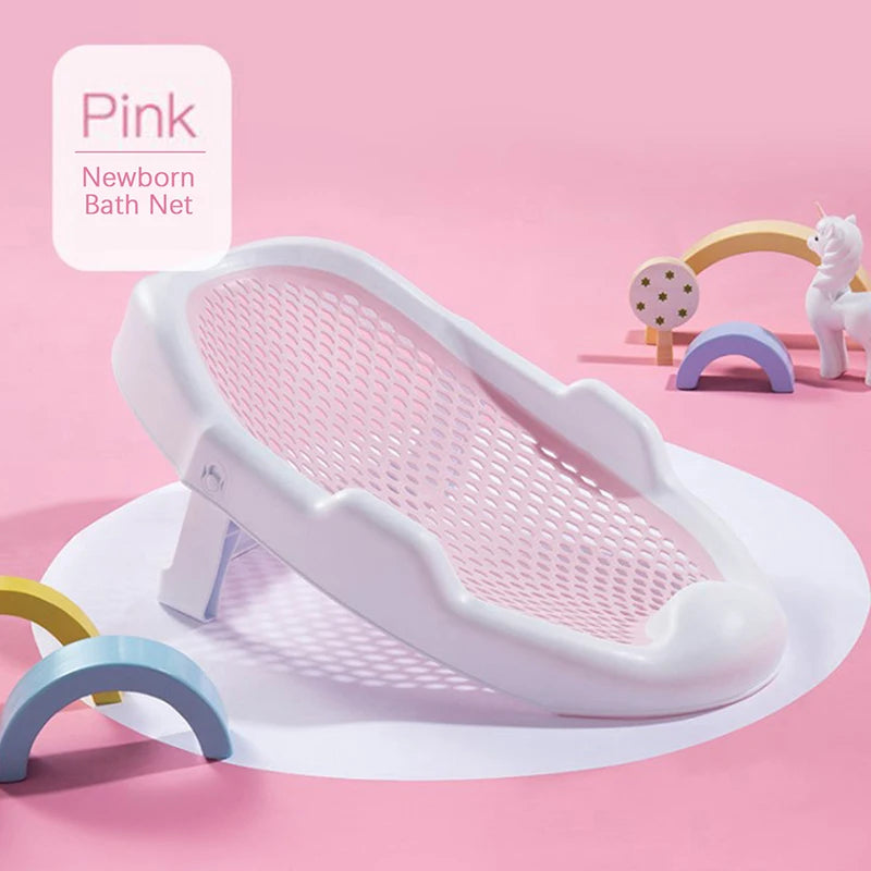White newborn bath net on a pink background, decorated with colorful toy arches and a unicorn figure. The text reads "Pink Newborn Bath Net" in the upper left corner.