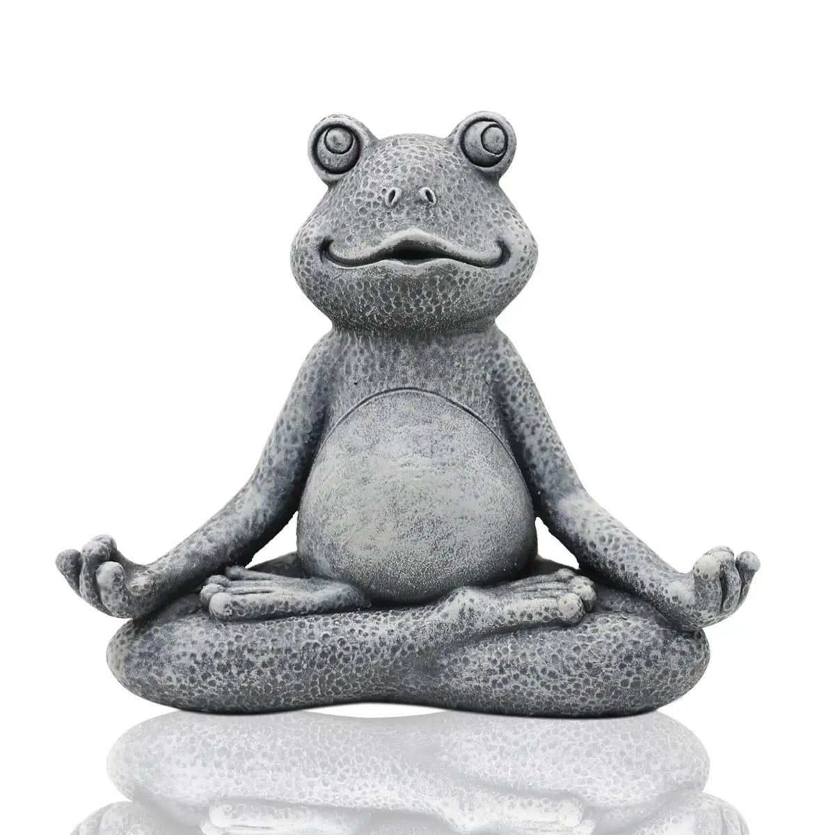 A gray, textured frog statue sits in a cross-legged yoga pose with closed eyes and a slight smile, reflecting peace and calmness.