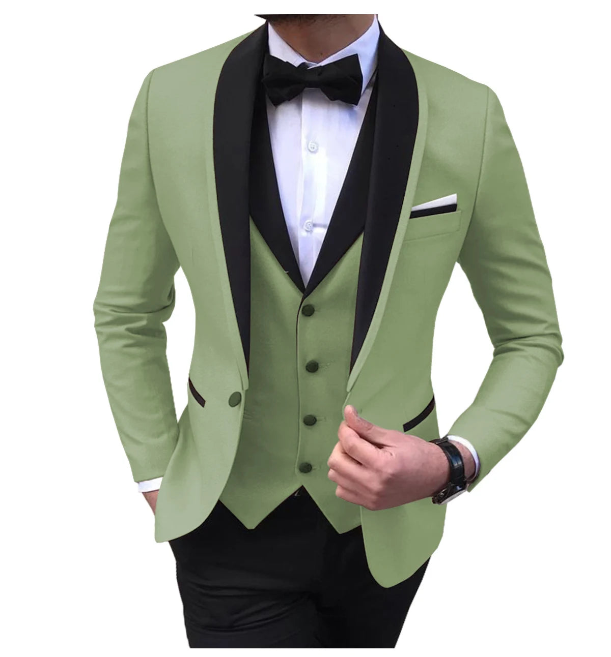 Man in a light green tuxedo with black lapels, wearing a white shirt and black bow tie, adjusting his jacket. The ensemble is completed with a black vest and watch.