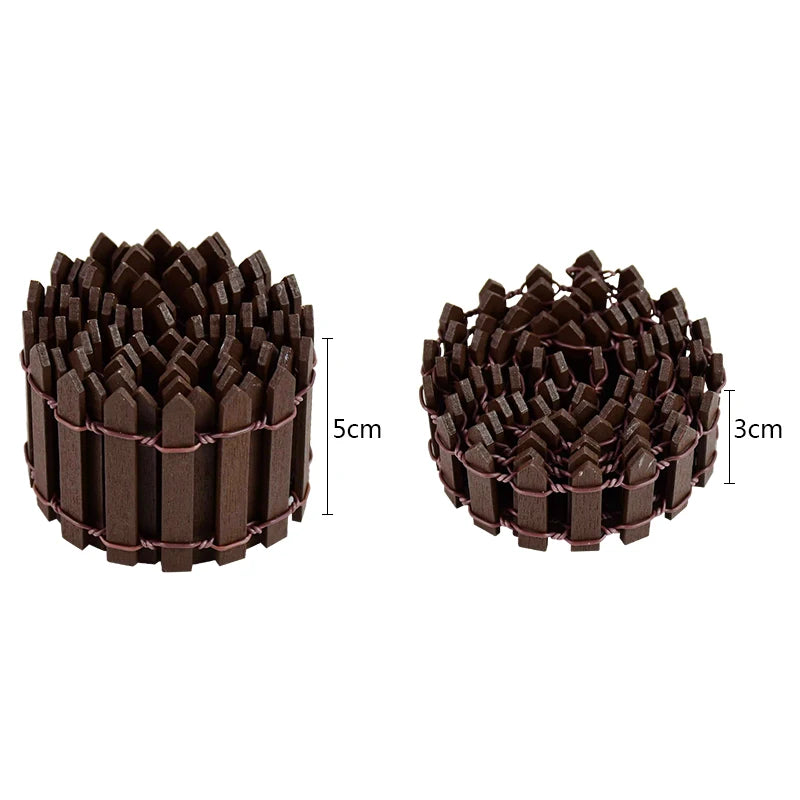 Two rolls of miniature brown picket fences are shown. The left roll measures 5cm in height, and the right roll is 3cm tall, both secured with thin wire.