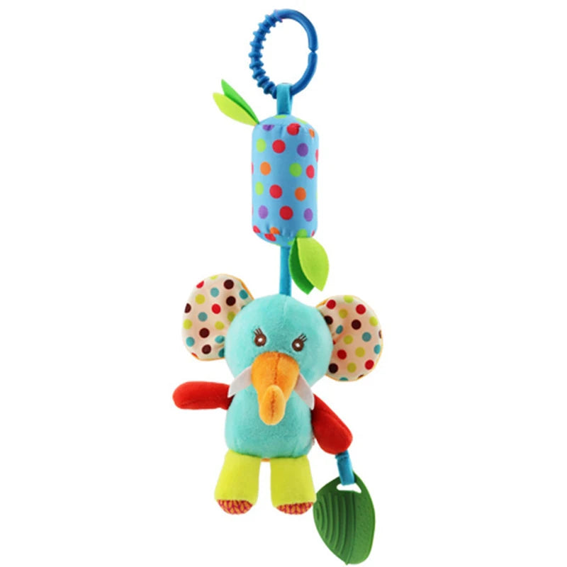 Colorful plush elephant toy with polka dots, green leaf teether, and a blue ring for hanging. The elephant features vibrant ears and an orange trunk.