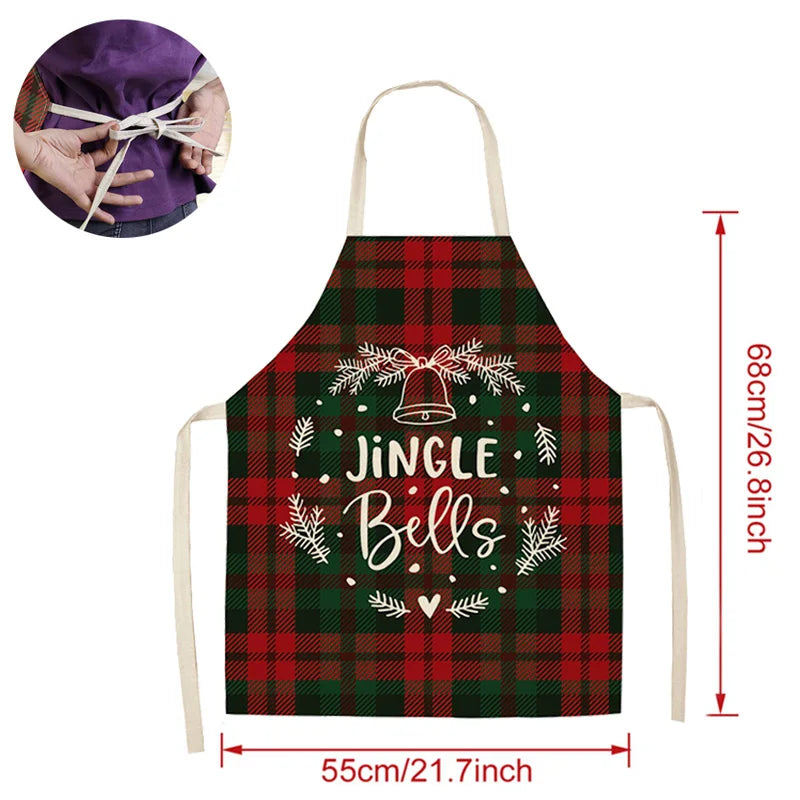 Red and green plaid apron with "Jingle Bells" design, featuring a bell and branches. Dimensions are 68cm by 55cm. Inset shows person tying apron at the back.