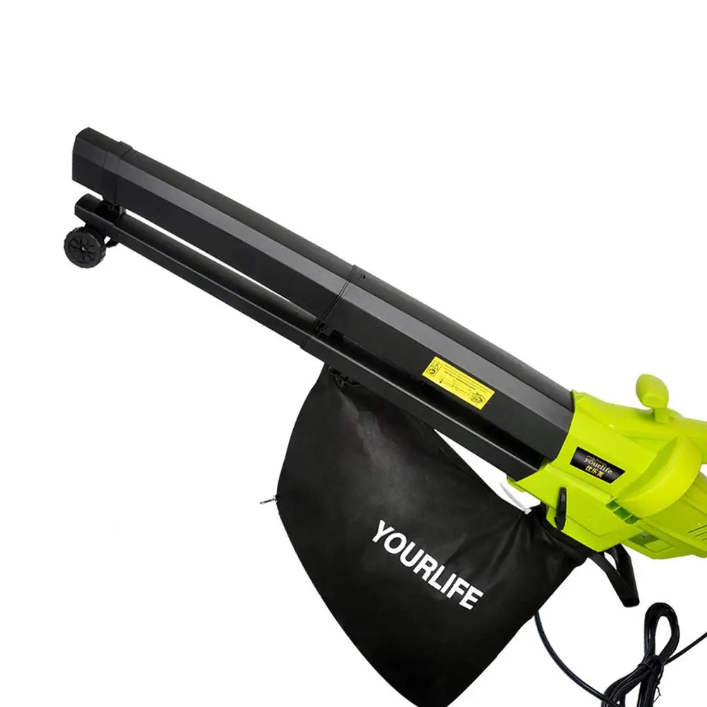 Bright green leaf blower with black nozzle and attached collection bag labeled "YOURLIFE." The blower features wheels for mobility and has a visible power cord.