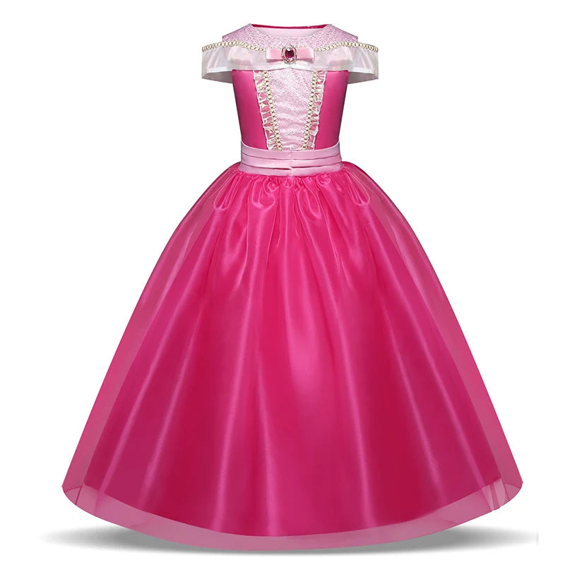 Pink princess dress with pearl-trimmed bodice, off-shoulder satin straps, bow accent at the waist, and a voluminous, flowing skirt.