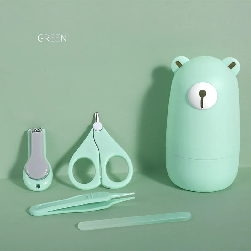 Mint green baby grooming kit with bear-shaped case, nail clipper, scissors, tweezers, and nail file on a matching green background.