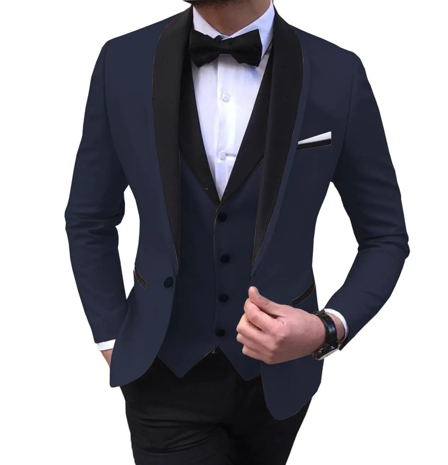 Man in a navy tuxedo with a black shawl collar, white shirt, black bow tie, and a pocket square. The suit is complemented by a wristwatch. Hands are adjusting the jacket.