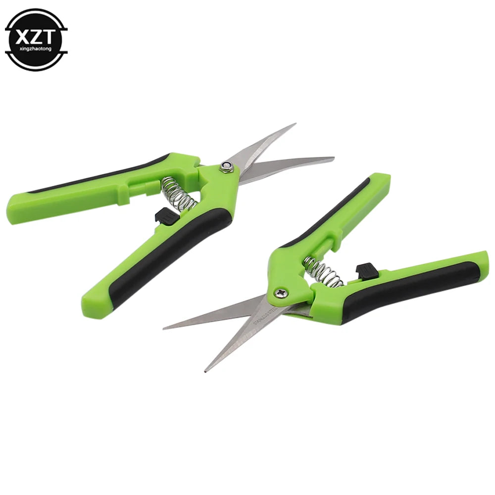 Two green and black pruning shears with spring-loaded handles, featuring sharp stainless steel blades. They are positioned facing opposite directions against a white background.