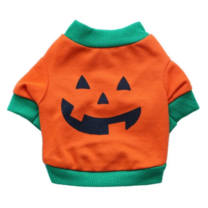 Orange pet sweater with a black Jack-o'-lantern face. Features green cuffs and collar, creating a festive Halloween look.