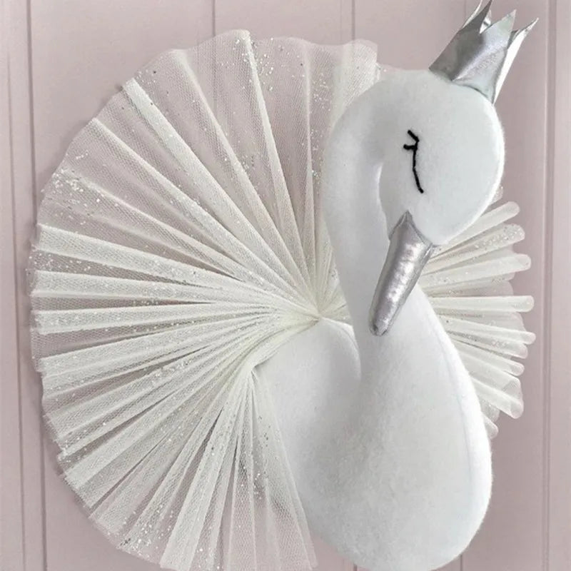 Elegant white swan wall decoration with a silver beak and a metallic crown, featuring a fan-shaped sparkling tulle behind it, set against a light pink background.