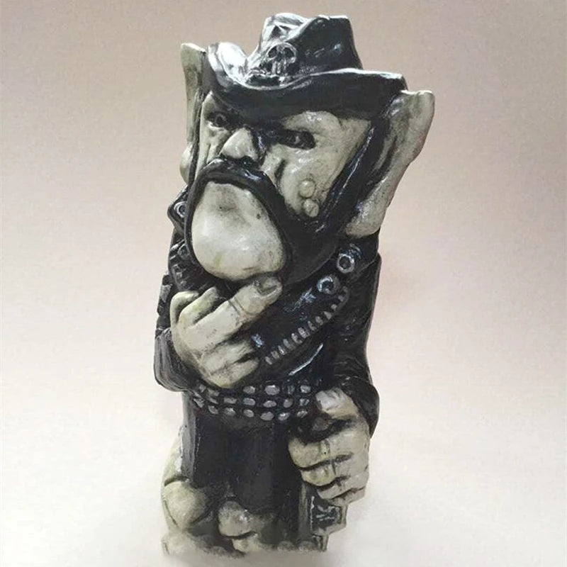 A ceramic figurine of a gruff-looking troll wearing a black cowboy hat and leather jacket, adorned with studs, arms crossed. The troll has exaggerated features and a mustache.