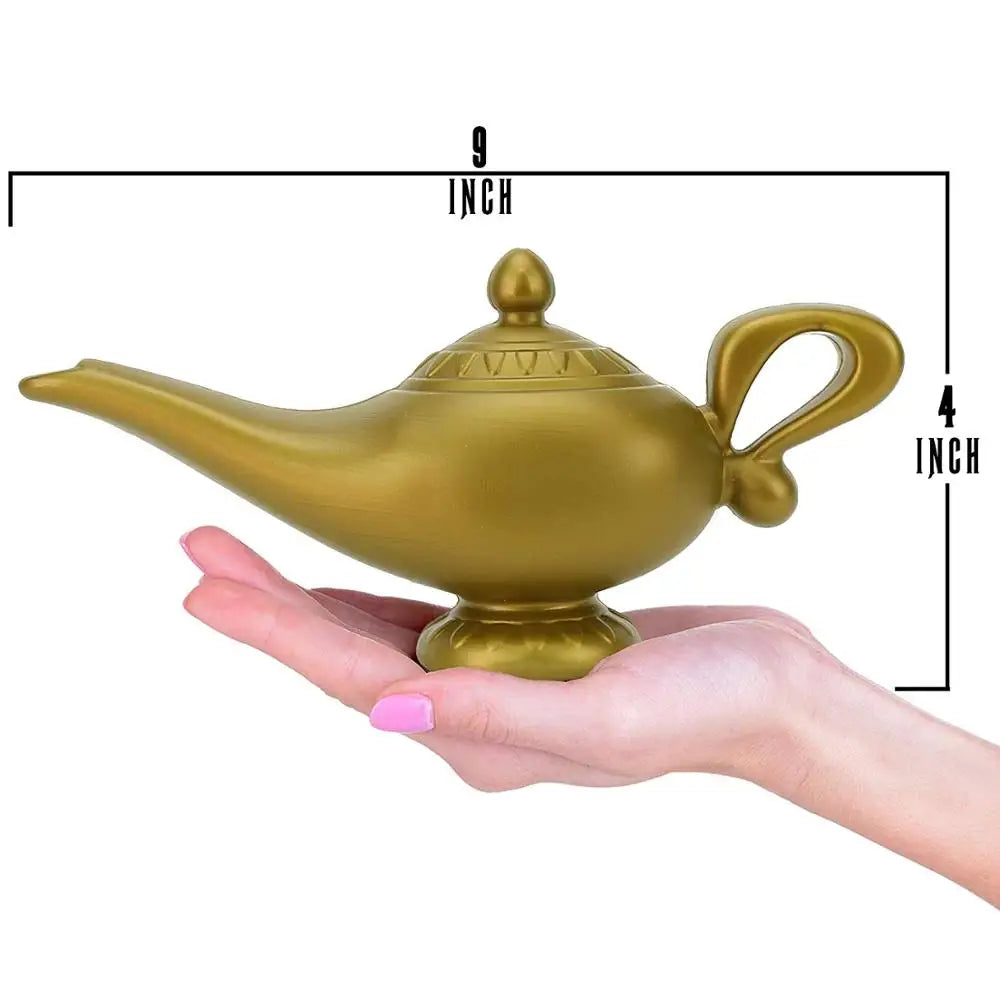 A hand holding a gold-colored ornate lamp measuring 9 inches wide and 4 inches tall. The lamp has a curved handle and spout, resembling a classic genie lamp.
