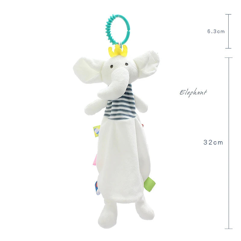 Soft elephant plush toy with a yellow crown and striped top, measuring 32cm in length. Attached to a teal ring for hanging. Various tags extend from its blanket body.