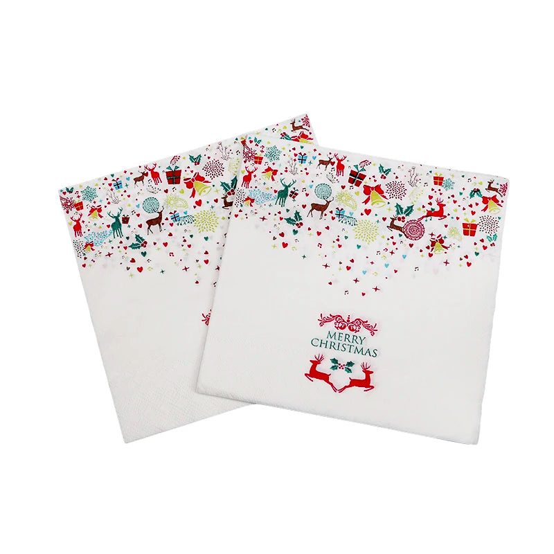 White Christmas-themed napkins with colorful festive patterns of reindeer, snowflakes, and gifts. The text "Merry Christmas" is printed on each napkin.