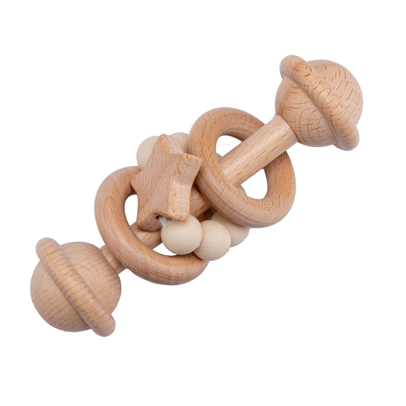 Wooden baby rattle with smooth rings, a star, and beige beads. The toy has a natural finish and is designed to be safe for infants to grasp and shake.