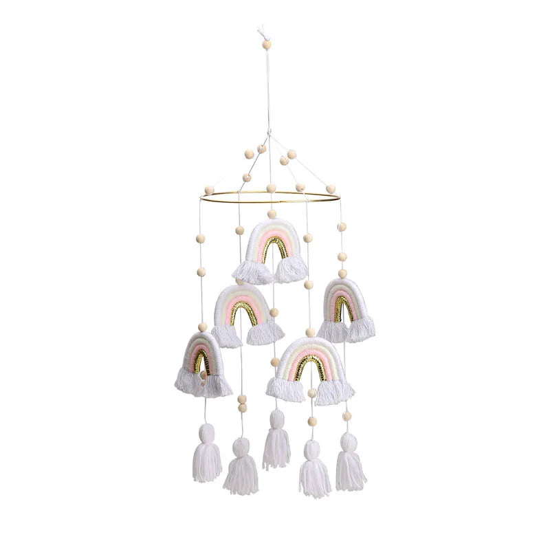 Hanging mobile with colorful yarn rainbows and wooden beads. Five rainbows dangle from a circular frame, each adorned with tassels, creating a whimsical, decorative accent.