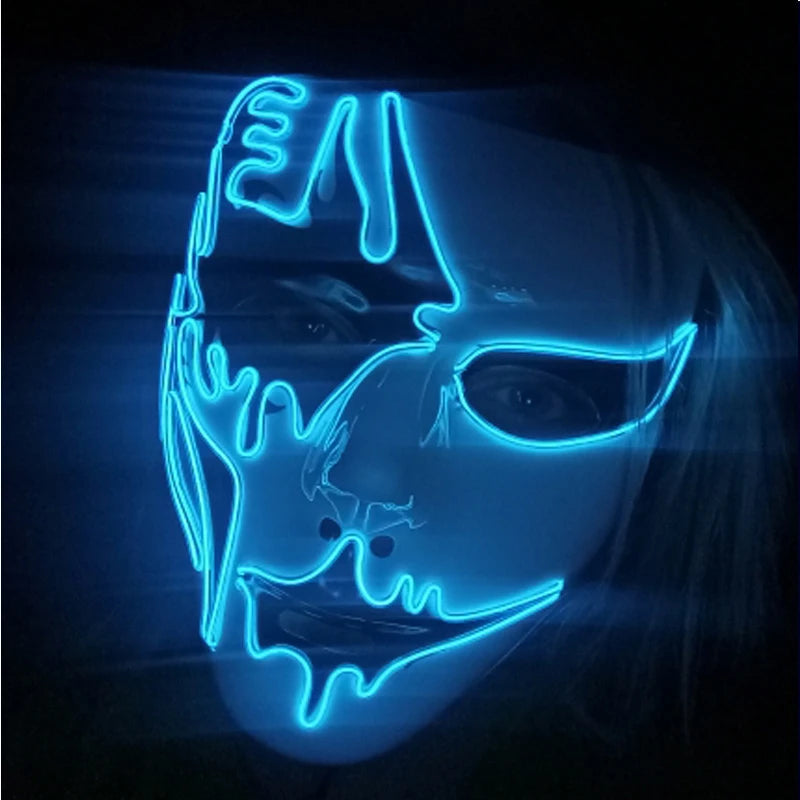 A person wearing a glowing neon blue mask with abstract, artistic design and cut-out eyes, set against a dark background. The mask gives an eerie, futuristic look.