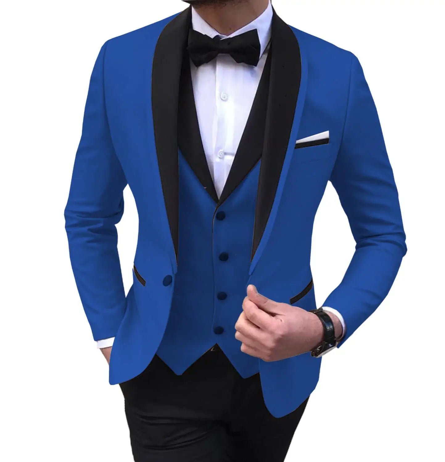 Man wearing a bright blue tuxedo with black lapels, a matching vest, black bow tie, and a white shirt. His left hand adjusts the jacket, showcasing a black wristwatch.