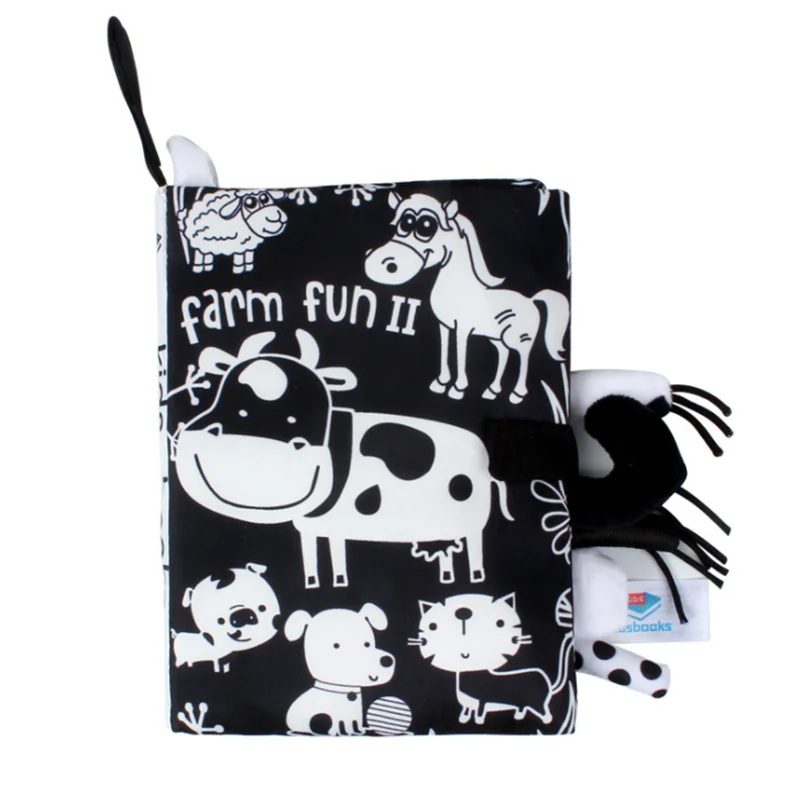 Black and white cloth book for babies titled "Farm Fun II" features cartoon animals, including a cow, horse, sheep, and dog, with textured details and a tag.