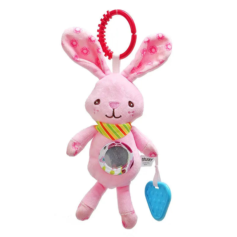 A pink plush bunny toy with floral ears, a green and yellow striped scarf, a clear belly button, a red clip ring on top, and a blue heart-shaped teether hanging from its side.