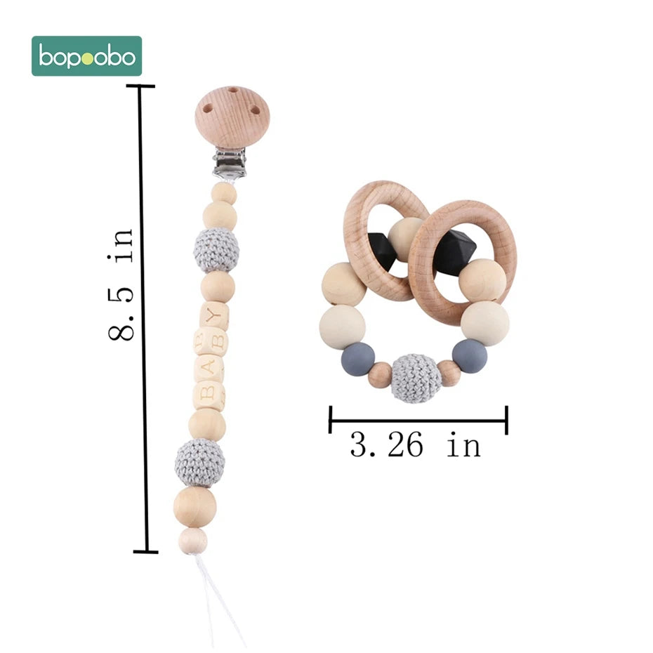 Wooden pacifier clip and teething ring set with crochet beads. The pacifier clip is 8.5 inches long, and the teething ring is 3.26 inches wide. Suitable for babies.