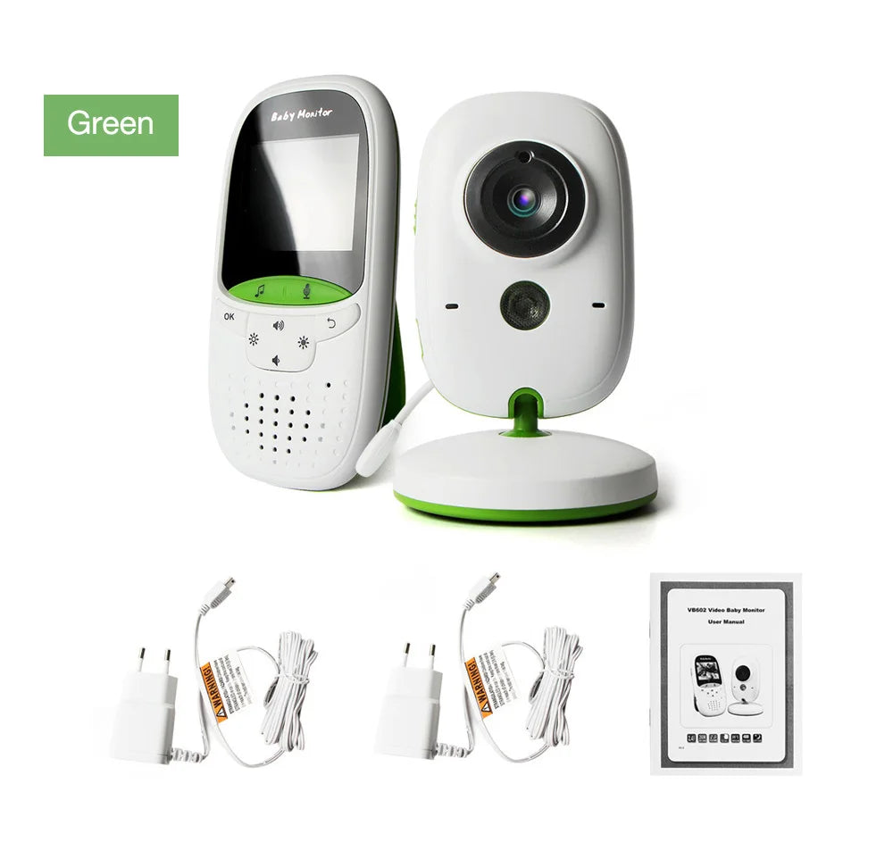 Green baby monitor set with camera, parent unit, two power adapters, and a user manual. The camera has a wide lens, and both units feature green accents.