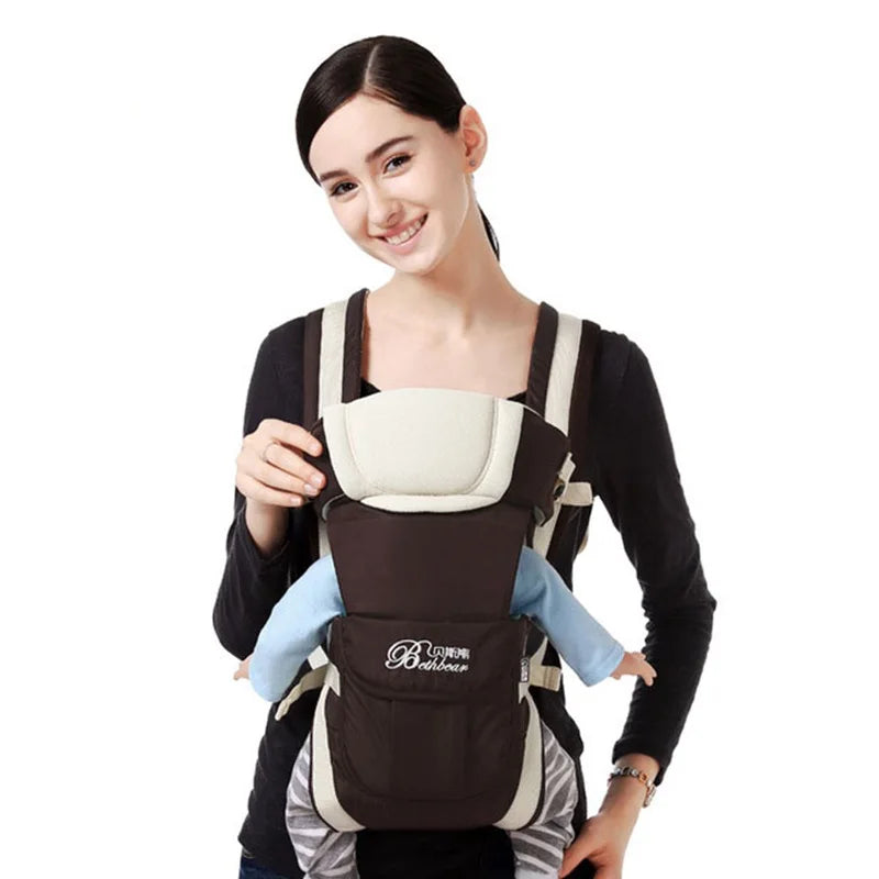 A woman smiles while using a black and cream baby carrier with a visible baby in a blue outfit. The carrier brand "Bebear" is written on the front.