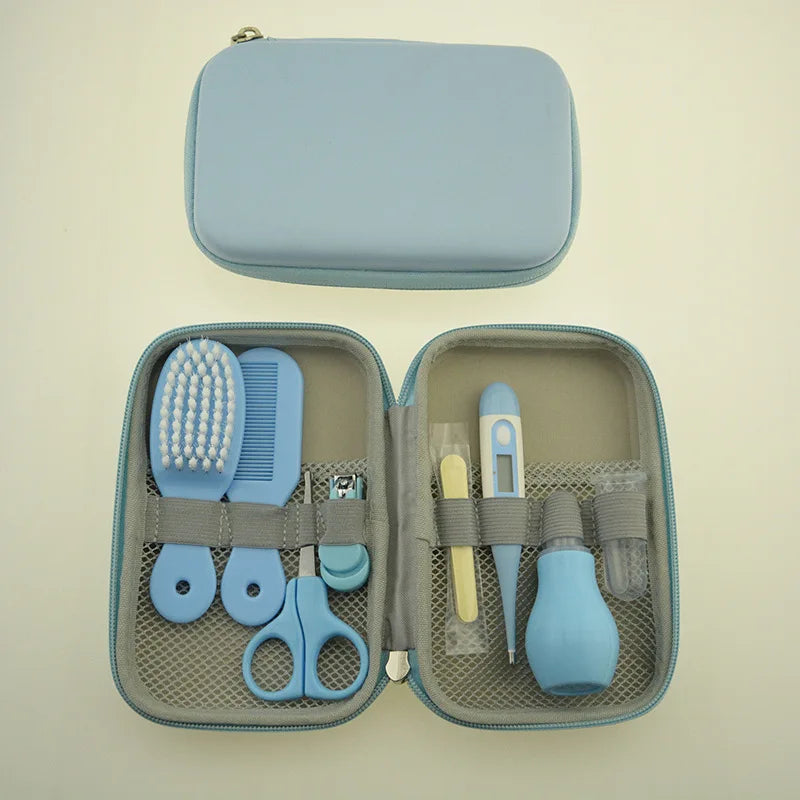 A light blue baby care kit with a brush, comb, scissors, nail clippers, thermometer, and more, neatly organized inside a zippered case.