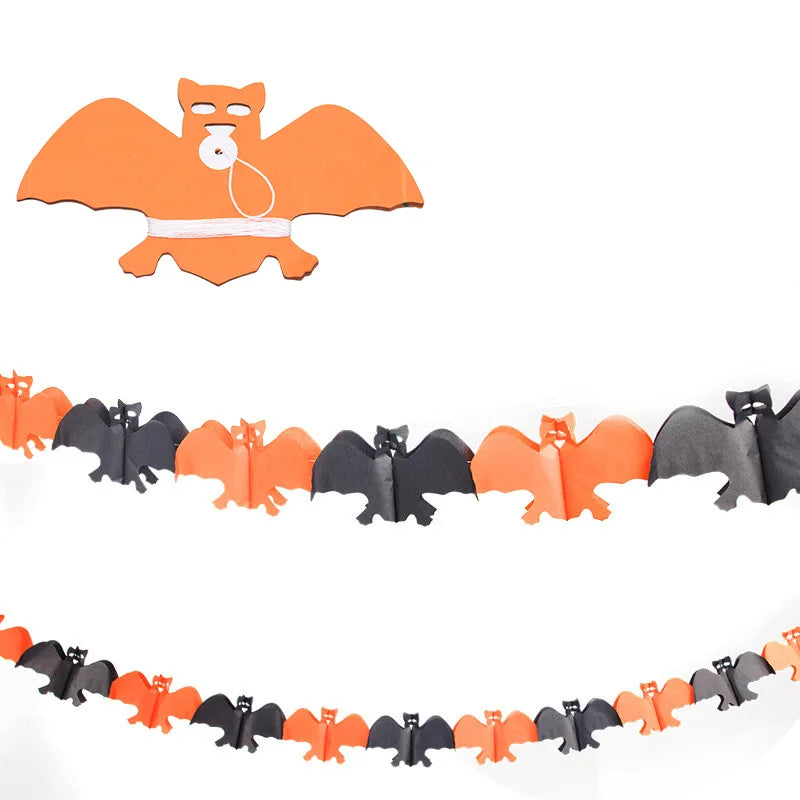 A Halloween-themed decoration featuring orange and black bat-shaped cutouts strung together in a garland. At the top, an orange bat figure is shown with a roll of white string. The bats alternate in color and are evenly spaced, creating a festive and spooky effect.