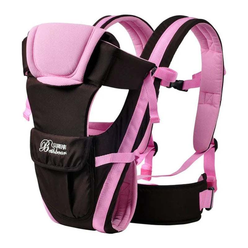 Pink and black baby carrier with padded straps, adjustable buckles, and a front pouch. Designed for ergonomic support and comfort. Branding visible on the front pocket.