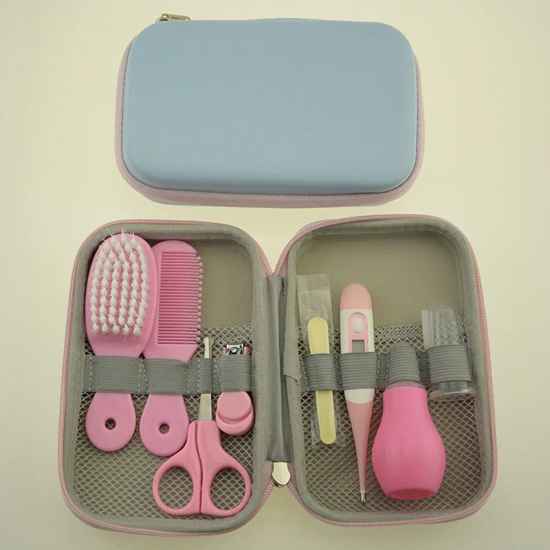 Pink and gray baby grooming kit with a brush, comb, scissors, nail clipper, thermometer, nasal aspirator, and other tools in a compact blue and pink zippered case.