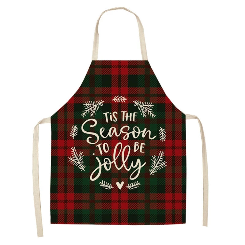 Plaid apron with red and green checks, featuring the phrase "Tis the Season to be Jolly" in white script surrounded by a wreath design.