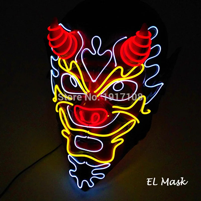 Neon mask shaped like a demon face with red horns, yellow and white outlines, and glowing red nose. The background is dark, enhancing the vibrant colors.