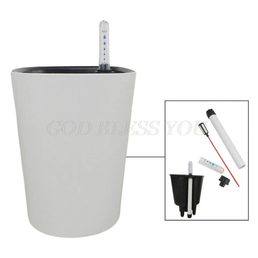 White self-watering planter with a water level indicator, showing disassembled parts: a black insert, a red water gauge, and a tube. The phrase "God Bless You" is lightly visible.