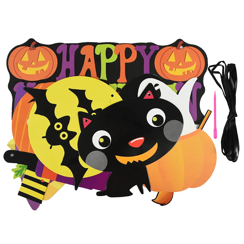 Colorful Halloween decoration with a smiling black cat, a yellow moon, flying black bat, and cheerful ghost. "Happy Halloween" is written in vibrant letters with two carved pumpkins. A black string and pink tool are seen to the right for assembly.