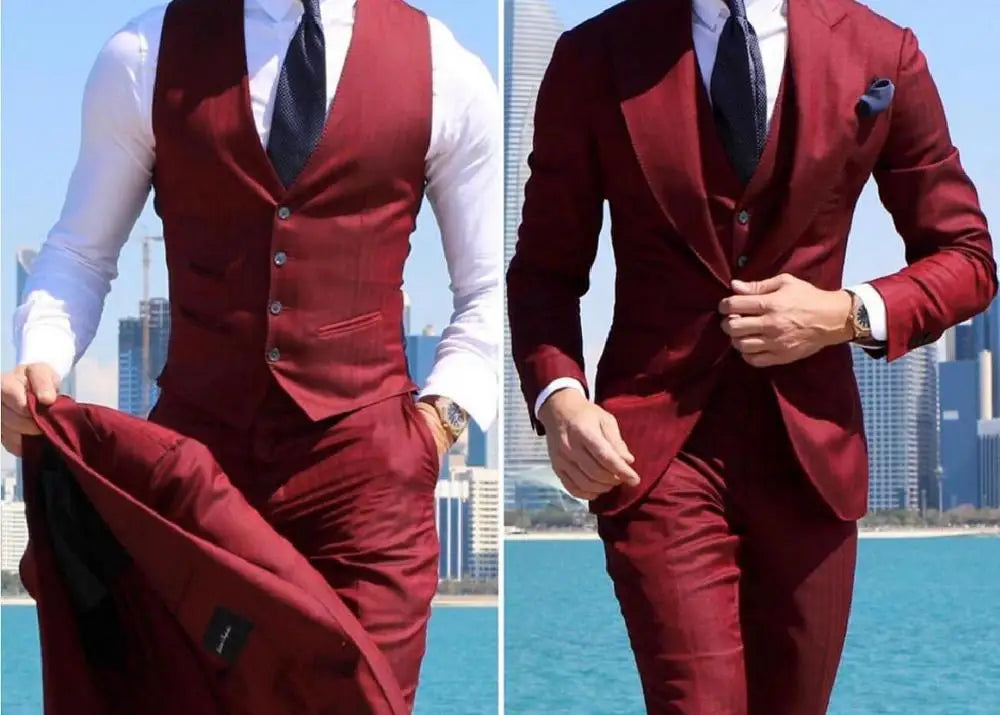 Man in a burgundy suit and tie stands by a waterfront with a city skyline in the background. Two images show him holding his jacket and walking confidently.