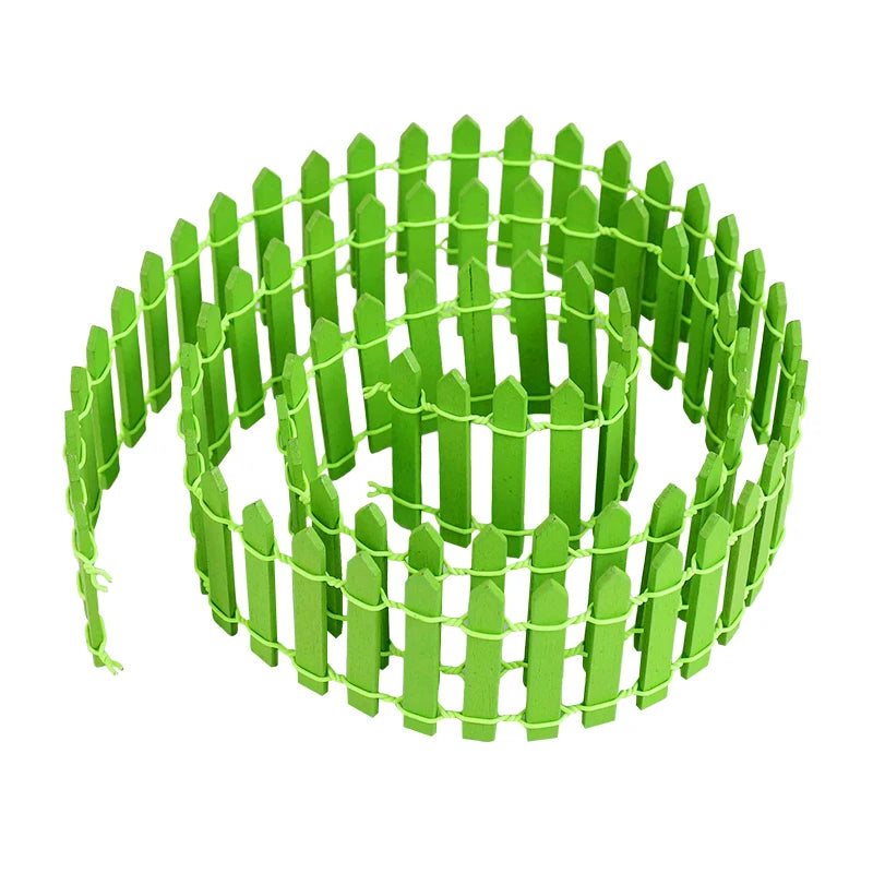 Coiled green picket fence made of small, pointed wooden slats connected with green string, suitable for decorative or miniature garden use.