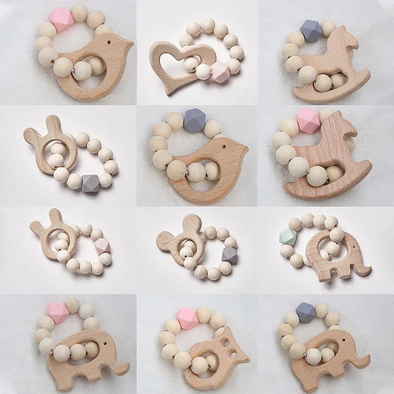 Wooden baby teethers in various shapes, including animals and hearts, with bead rings. Each teether features natural wood and colorful beads in pastel shades of pink, blue, and green.