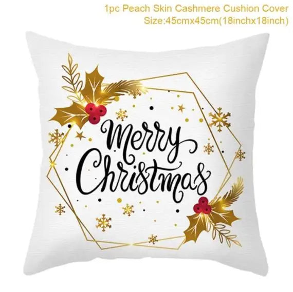 White cushion cover with "Merry Christmas" in elegant black script. Adorned with red berries, gold holly leaves, snowflakes, and geometric gold accents. Size: 45cm x 45cm.