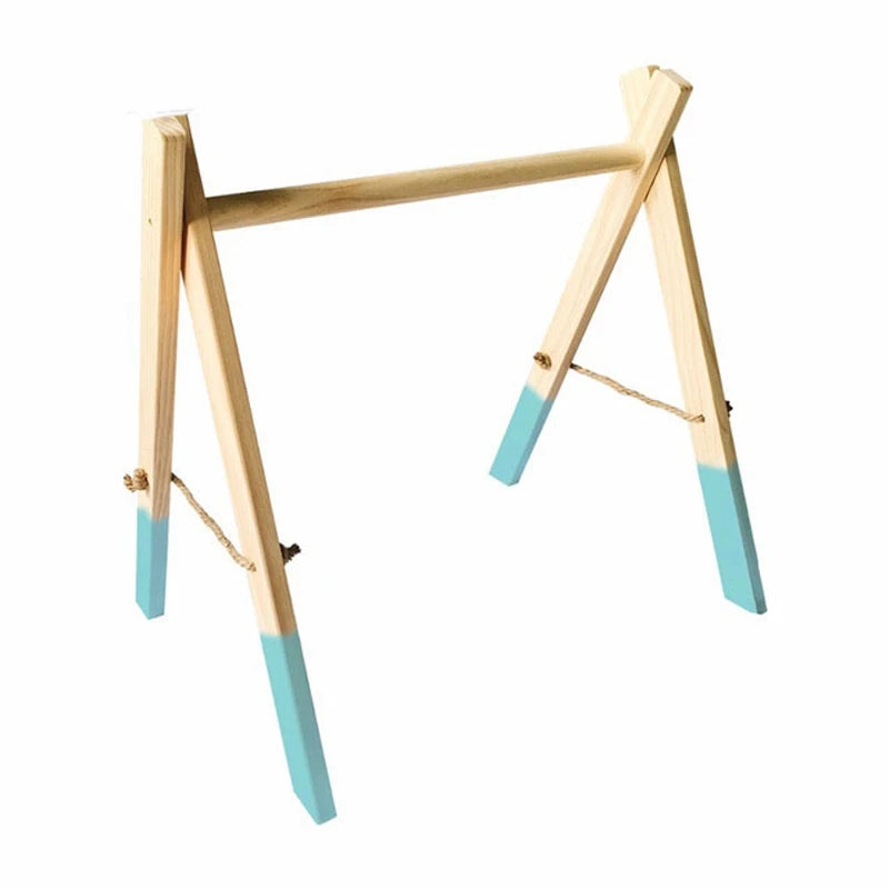 Light wooden trestle with teal painted tips. The A-frame design features a horizontal bar at the top and supporting ropes on the sides for stability.