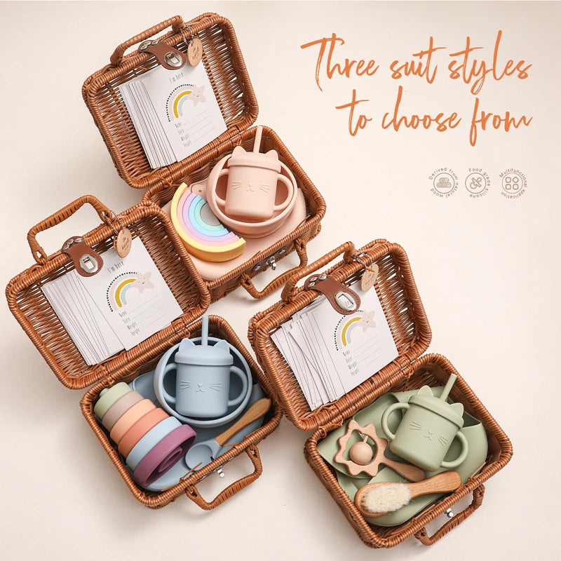 Three wicker baskets, each containing a pastel-colored baby set with cups, bowls, and toys. The image highlights "Three suit styles to choose from" in cursive text.