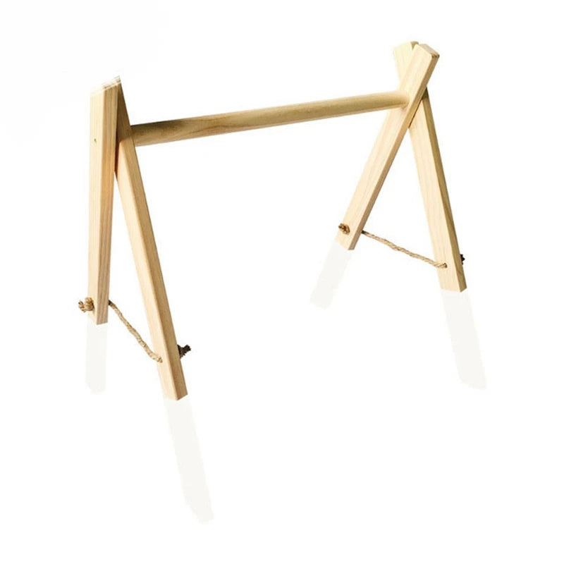 Wooden tabletop A-frame easel with a crossbar, designed for holding small canvases or signs. It has a simple, natural finish with rope securing the legs for stability.