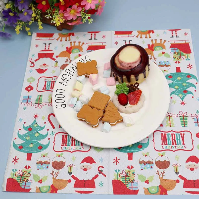 Plate with assorted cookies, marshmallows, strawberries, and a chocolate-drizzled dessert on a Christmas-themed mat with "Good Morning" text, surrounded by colorful flowers.