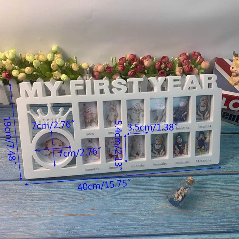 White photo frame for baby's first year with 12 small slots for monthly photos and one larger oval slot for newborn. Decorative crown design and measurements labeled in blue.