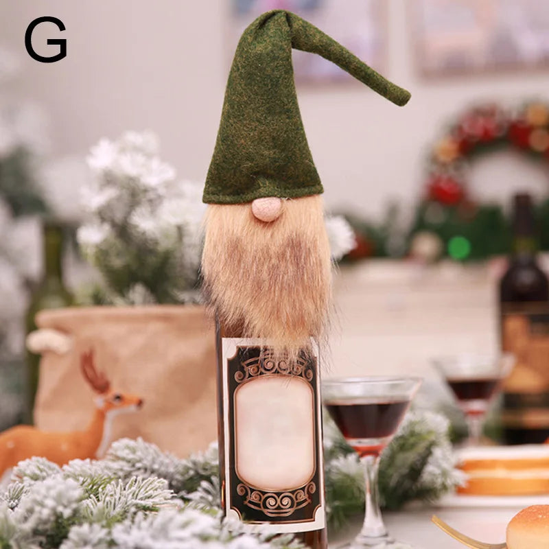 Gnome wine bottle topper with a green hat and fluffy beard sits on a festive table decorated with pine branches and a small deer figurine in the background.
