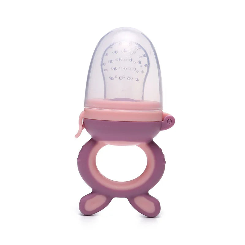Pink and purple silicone baby food feeder with a round ring handle and a transparent perforated silicone top for safe and easy feeding.