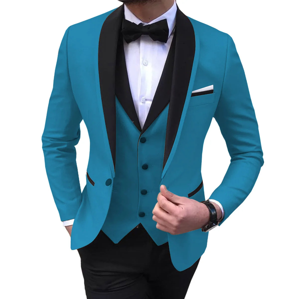 Man in a vibrant turquoise suit with black lapels, wearing a white shirt and black bow tie. His hand adjusts the suit jacket, and he wears a black watch.
